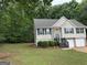 Charming home with a well-maintained lawn, green shutters, and a two-car garage at 140 Clover Valley Dr, Covington, GA 30016