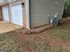 Exterior shot of the side of a house with a two car garage and green grass at 140 Clover Valley Dr, Covington, GA 30016