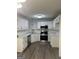 Bright kitchen with stainless steel appliances, white cabinets, and hardwood floors at 140 Clover Valley Dr, Covington, GA 30016