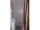 A compact bathroom has a single sink and toilet with striped shower curtain at 1320 Labelle St, Jonesboro, GA 30238