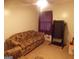 Functional bedroom featuring comfortable seating area, a treadmill, and natural light at 1320 Labelle St, Jonesboro, GA 30238