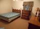 Bedroom features a bed and dresser and decoratively carved wooden headboard at 1320 Labelle St, Jonesboro, GA 30238
