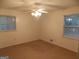 Bright bedroom with a ceiling fan and natural light from two windows at 1320 Labelle St, Jonesboro, GA 30238