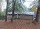 Exterior of a ranch style home with brick facade surrounded by lush trees and fallen leaves at 1320 Labelle St, Jonesboro, GA 30238