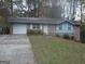 Charming single-story home featuring a brick facade, attached garage, and a well-manicured front lawn at 1320 Labelle St, Jonesboro, GA 30238