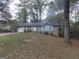 Charming front yard of a single story home with brick facade and blue shutters at 1320 Labelle St, Jonesboro, GA 30238