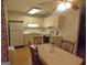 Kitchen with white cabinets and dining table featuring a ceiling fan and neutral colors at 1320 Labelle St, Jonesboro, GA 30238