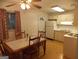Eat in kitchen with white appliances and cabinets, and wood table for dining at 1320 Labelle St, Jonesboro, GA 30238