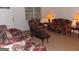 Cozy living room featuring matching floral sofas and chairs offering a comfortable gathering space at 1320 Labelle St, Jonesboro, GA 30238