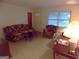 Inviting living room showcasing floral sofa and chair, a cozy space for relaxation with natural light at 1320 Labelle St, Jonesboro, GA 30238