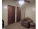 Cozy living room features comfortable armchairs and two closets for ample storage space at 1320 Labelle St, Jonesboro, GA 30238