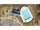 Stunning aerial view of the community pool, playground, and parking area nestled in a well-manicured neighborhood at 604 Whitman Ln # 27, Stockbridge, GA 30281
