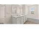 Bright bathroom with double vanity, soaking tub, walk-in shower, and large mirror at 604 Whitman Ln # 27, Stockbridge, GA 30281