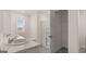 Bathroom with dual sinks, shower, and storage closet with wire shelving near a sunlit window at 604 Whitman Ln # 27, Stockbridge, GA 30281