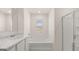 Well-lit bathroom with soaking tub, glass shower, and vanity with marble countertop at 604 Whitman Ln # 27, Stockbridge, GA 30281