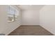 A clean and bright bedroom features hardwood floors, neutral paint and a large window at 604 Whitman Ln # 27, Stockbridge, GA 30281