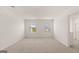 Spacious, well-lit bedroom with carpet flooring, two windows, and a door leading to the bathroom at 604 Whitman Ln # 27, Stockbridge, GA 30281