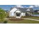 Community clubhouse featuring a covered seating area, a well-maintained lawn, and attractive landscaping at 604 Whitman Ln # 27, Stockbridge, GA 30281