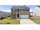 Beautiful two-story brick home with a well-manicured lawn and an attached two-car garage at 604 Whitman Ln # 27, Stockbridge, GA 30281