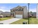 A two-story brick home with a manicured lawn, an attached two-car garage, and a private backyard at 604 Whitman Ln # 27, Stockbridge, GA 30281