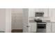 Modern kitchen features stainless steel appliances, granite countertops, walk-in pantry, and white cabinets at 604 Whitman Ln # 27, Stockbridge, GA 30281