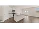 Bright kitchen features white cabinetry, granite countertops, stainless steel appliances, and center island with sink at 604 Whitman Ln # 27, Stockbridge, GA 30281