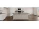 Modern kitchen boasts white cabinets, granite countertops, a center island with sink and stainless steel appliances at 604 Whitman Ln # 27, Stockbridge, GA 30281