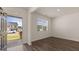 Bright living room featuring hardwood floors, neutral paint, and an open doorway with views of the neighborhood at 604 Whitman Ln # 27, Stockbridge, GA 30281