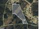 Aerial view of the land, surrounded by trees and residential streets, showcasing its location and size at 3255 Flat Shoals Sw Rd, Conyers, GA 30094