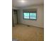 Bedroom showcasing a window view of trees, built-in closet and patterned carpet at 3255 Flat Shoals Sw Rd, Conyers, GA 30094