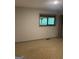 Cozy bedroom with a window offering a view of the outdoors and neutral carpet at 3255 Flat Shoals Sw Rd, Conyers, GA 30094