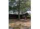 Rustic home featuring a large wrap-around porch, offering an inviting space to relax in a secluded, wooded setting at 3255 Flat Shoals Sw Rd, Conyers, GA 30094