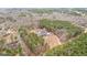 High angle captures the house and pool, nestled amidst a lush and expansive forest at 203 Shelby Ln, Fayetteville, GA 30215