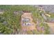 Aerial shot of a home with an in-ground pool, detached garage and dense surrounding forest at 203 Shelby Ln, Fayetteville, GA 30215