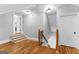Attic featuring stairs, wood railings, hardwood floors, and multiple entrances to finished spaces at 203 Shelby Ln, Fayetteville, GA 30215