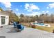 Inviting back deck featuring comfortable blue chairs and a view of the pool and pool house, perfect for outdoor relaxation at 203 Shelby Ln, Fayetteville, GA 30215