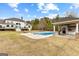 Spacious backyard featuring an in-ground pool, pool house, and well-manicured lawn, ideal for outdoor activities and entertaining at 203 Shelby Ln, Fayetteville, GA 30215