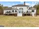 Expansive backyard featuring a multi-level deck, lush lawn, and mature trees at 203 Shelby Ln, Fayetteville, GA 30215