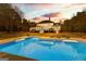 Serene backyard with an in-ground pool, sundeck, and lush landscaping, creating a tranquil escape with ample space for leisure at 203 Shelby Ln, Fayetteville, GA 30215