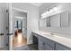 Bright bathroom with a vanity, marble countertop, slate tile floor, and a bedroom view at 203 Shelby Ln, Fayetteville, GA 30215