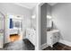 Dual vanity bathroom with slate floors, a shower, and views into the main bedroom at 203 Shelby Ln, Fayetteville, GA 30215