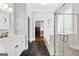 Bright bathroom featuring black slate flooring, a walk-in shower, and a standalone soaking tub at 203 Shelby Ln, Fayetteville, GA 30215