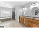 Bathroom features a dual sink vanity, soaking tub, and glass enclosed shower, offering luxury and convenience at 203 Shelby Ln, Fayetteville, GA 30215