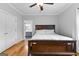 Bedroom boasts hardwood floors, a ceiling fan, and an open doorway to a bathroom, creating comfort and convenience at 203 Shelby Ln, Fayetteville, GA 30215
