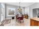 Bright dining area with large windows, chandelier lighting, and tiled floors at 203 Shelby Ln, Fayetteville, GA 30215