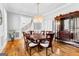 Inviting dining room featuring a wooden table with seating for eight and hardwood floors at 203 Shelby Ln, Fayetteville, GA 30215