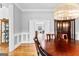 Close-up of a dining room featuring wood floors, paneled walls, and views into another room at 203 Shelby Ln, Fayetteville, GA 30215