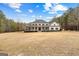 Charming two-story home with a spacious front yard and classic architectural details at 203 Shelby Ln, Fayetteville, GA 30215
