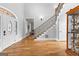 Stately foyer featuring hardwood floors, an elegant staircase, and views to the living spaces at 203 Shelby Ln, Fayetteville, GA 30215