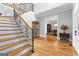 Grand foyer featuring a wooden staircase, hardwood floors, and views into the dining room at 203 Shelby Ln, Fayetteville, GA 30215